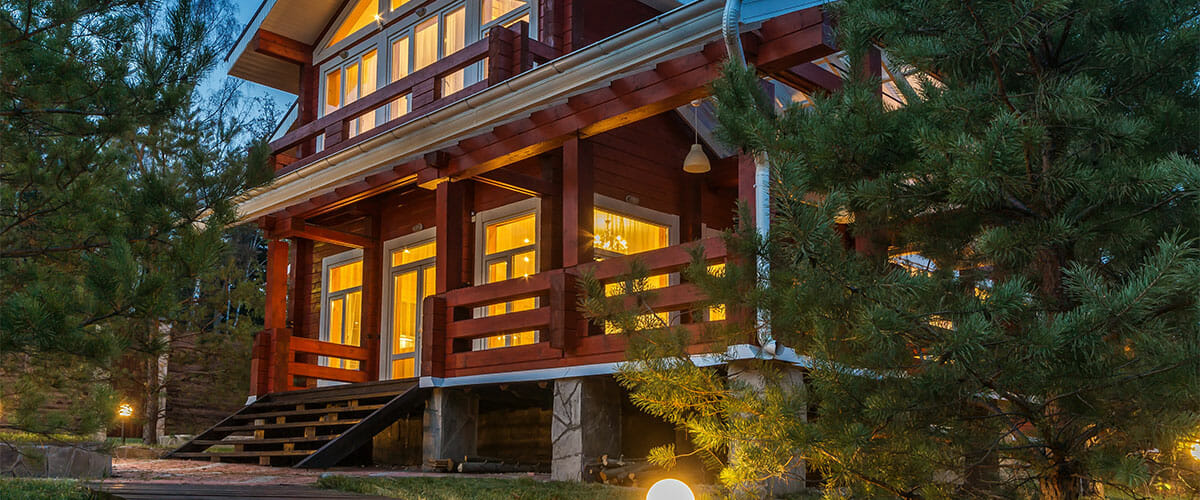 Large wood house surrounded by evergreen trees in Washington