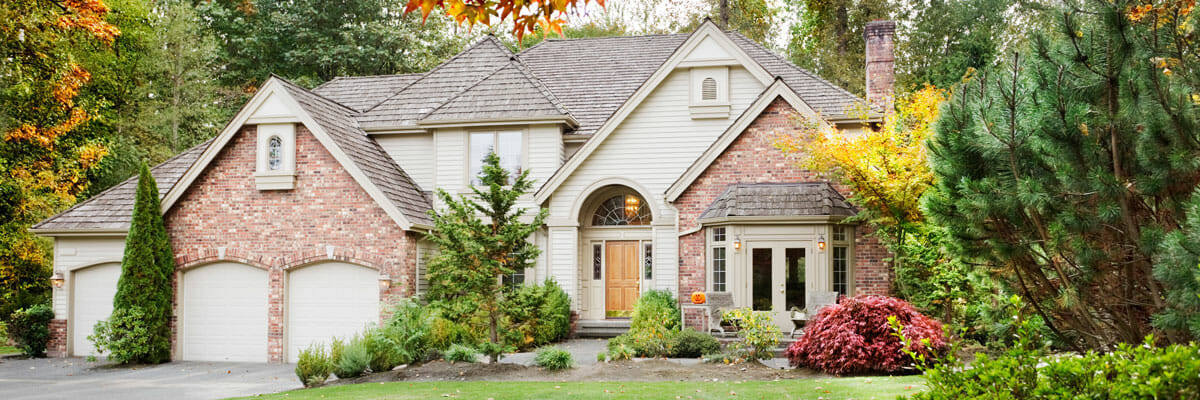 Large brick house surrounded by trees in Washington